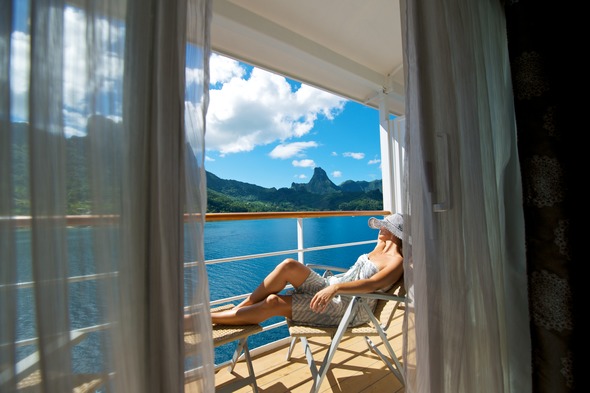 Relaxing on the balcony on a Paul Gauguin cruise
